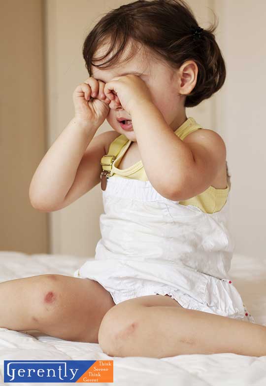 child rubbing eyes